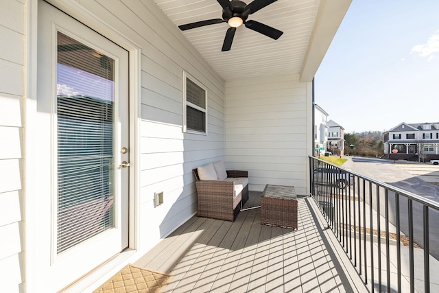 balcony featuring a residential view and a ceiling fan