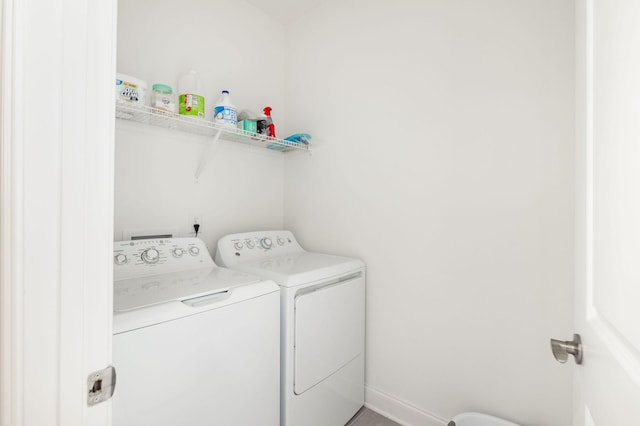 laundry room featuring laundry area, independent washer and dryer, and baseboards