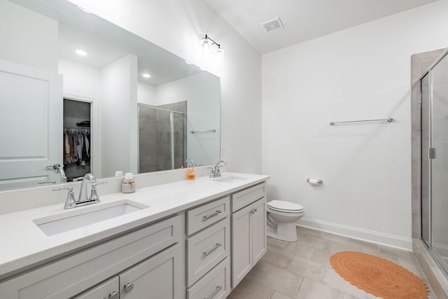 full bathroom with double vanity, a shower stall, visible vents, and a sink