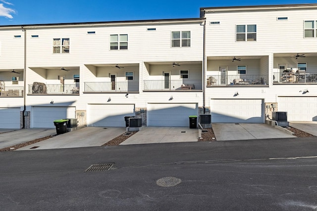 view of front of property featuring central air condition unit, ceiling fan, and an attached garage