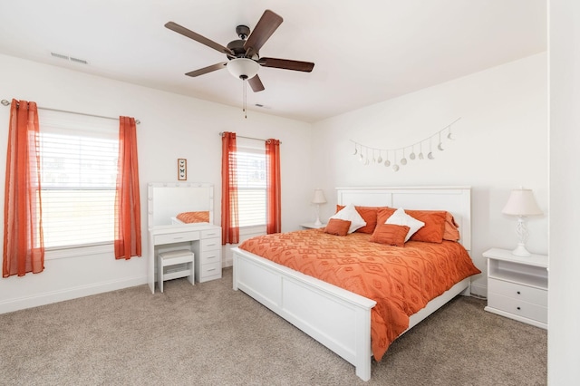 bedroom featuring visible vents, ceiling fan, light carpet, and baseboards