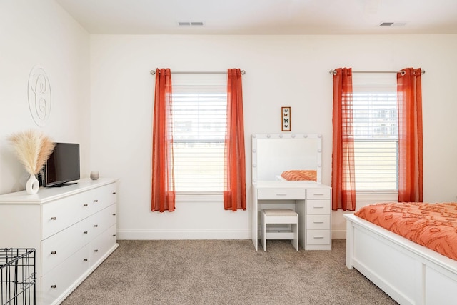 bedroom featuring light carpet, visible vents, and baseboards