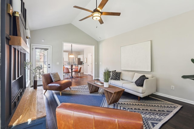 living area featuring high vaulted ceiling, ceiling fan, baseboards, and wood finished floors