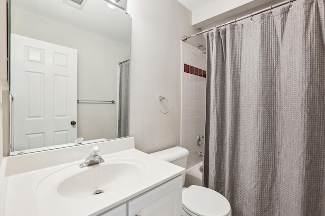 bathroom featuring visible vents, shower / tub combo with curtain, vanity, and toilet