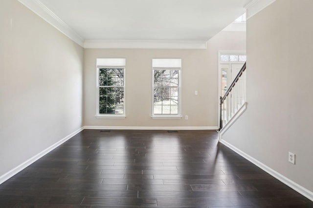 interior space featuring ornamental molding, dark wood finished floors, baseboards, and stairs