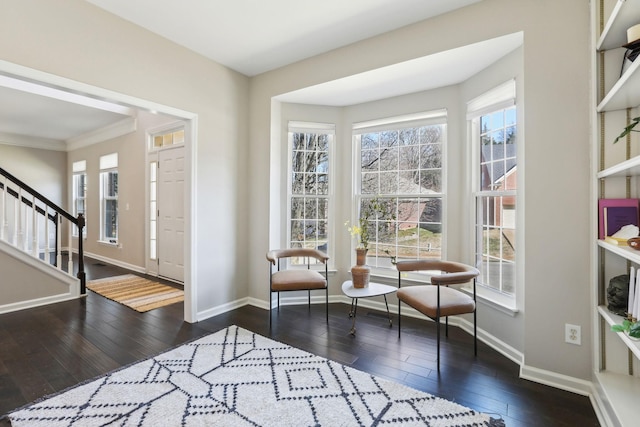 foyer entrance featuring stairway, hardwood / wood-style flooring, and baseboards