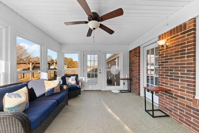 sunroom / solarium featuring ceiling fan and plenty of natural light