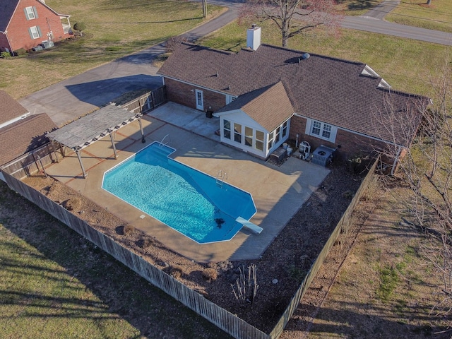 view of pool with a fenced backyard, a diving board, a fenced in pool, and a patio