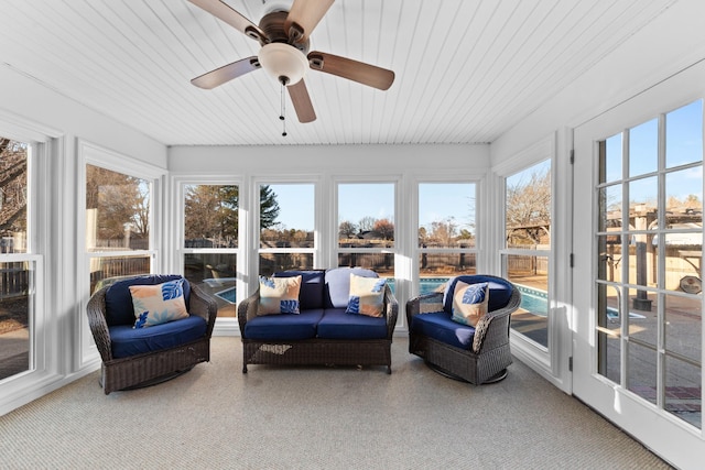 sunroom featuring ceiling fan, plenty of natural light, and wooden ceiling