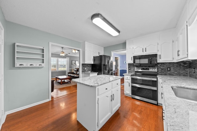 kitchen with dark wood-style flooring, white cabinets, and black appliances