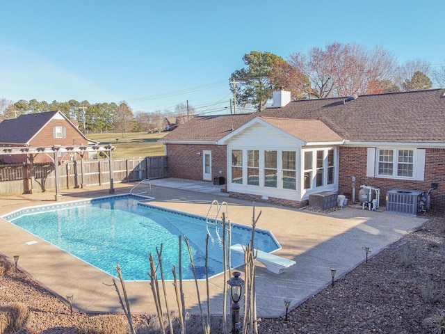 view of swimming pool featuring a fenced in pool, fence, cooling unit, and a patio