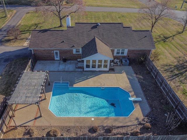 view of swimming pool with a patio area, a fenced backyard, a diving board, and a fenced in pool