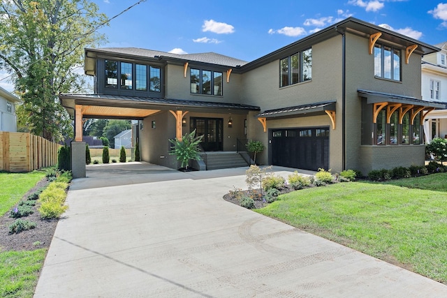 view of front of property with a standing seam roof, driveway, fence, and metal roof