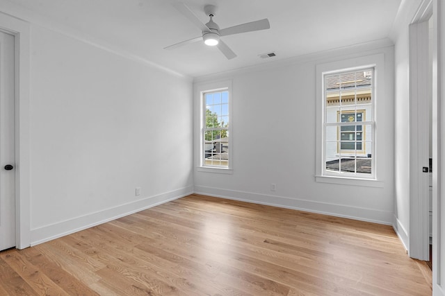 unfurnished bedroom featuring light wood-style flooring, crown molding, visible vents, and baseboards