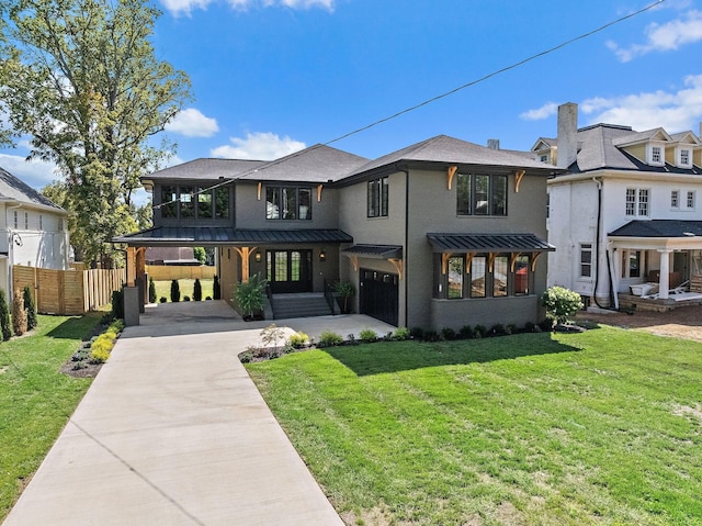 view of front facade featuring driveway, a standing seam roof, a front yard, and fence