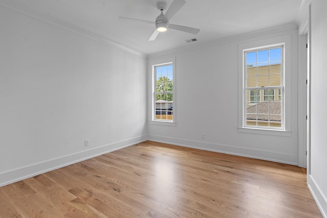 unfurnished room with baseboards, plenty of natural light, light wood finished floors, and ceiling fan