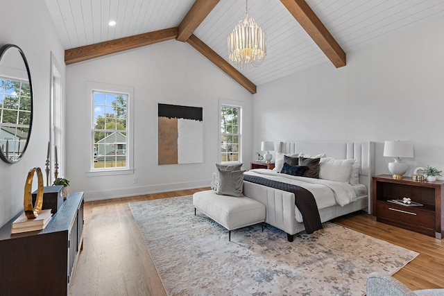 bedroom featuring vaulted ceiling with beams, baseboards, wood finished floors, and a notable chandelier