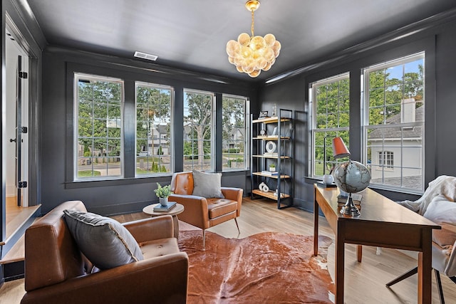 sunroom with visible vents and a notable chandelier