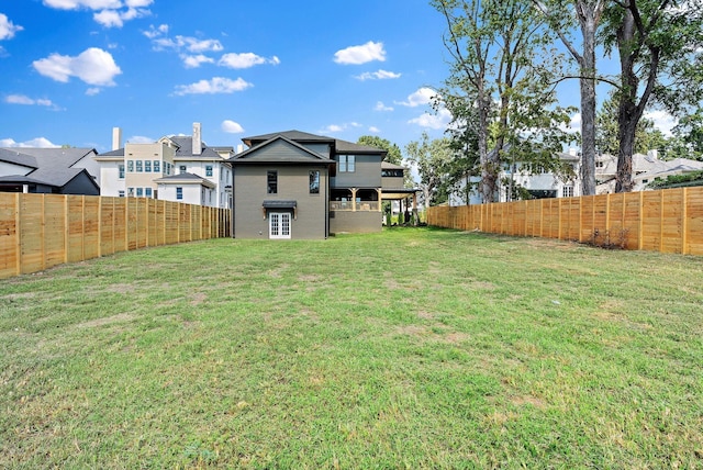 view of yard featuring a fenced backyard and a residential view