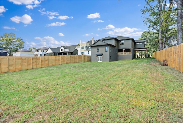 view of yard with a fenced backyard and a residential view