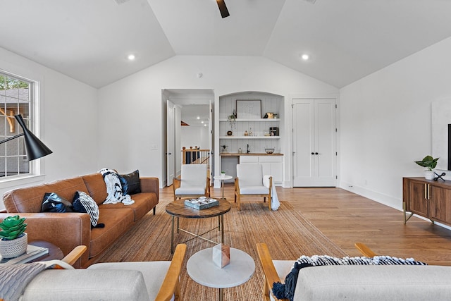 living room with lofted ceiling, ceiling fan, recessed lighting, baseboards, and light wood-type flooring