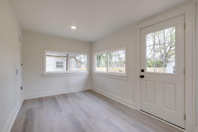 entryway featuring light wood-style floors, baseboards, and recessed lighting