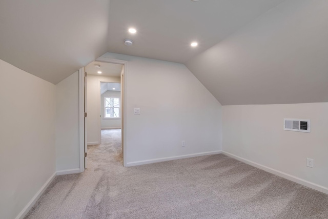 bonus room featuring carpet floors, lofted ceiling, visible vents, and baseboards