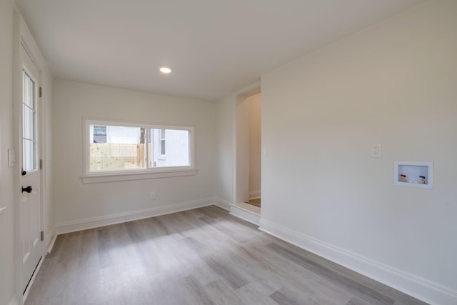 unfurnished room featuring recessed lighting, baseboards, and wood finished floors