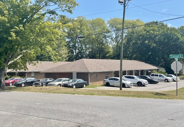 view of vehicle parking featuring an attached garage