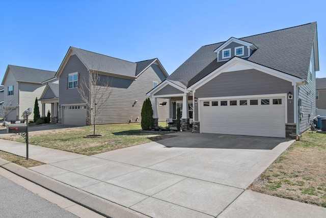 view of front facade with central air condition unit, concrete driveway, a front lawn, and a shingled roof