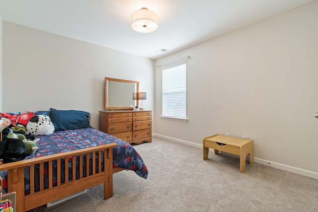 carpeted bedroom with visible vents and baseboards