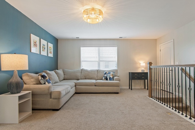 carpeted living room with visible vents and baseboards