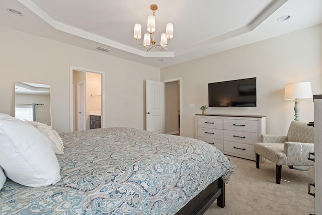 bedroom with a tray ceiling, visible vents, a chandelier, and light carpet