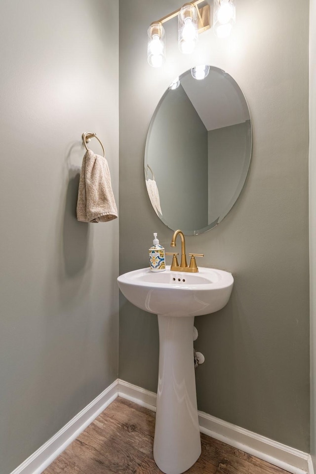 bathroom featuring baseboards and wood finished floors