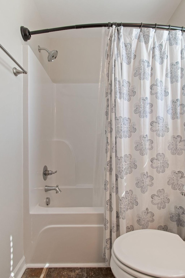 bathroom with toilet and shower / bath combo