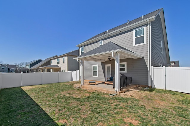 rear view of house with a lawn, a ceiling fan, a fenced backyard, a residential view, and a patio area