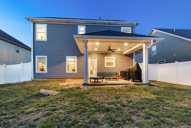 rear view of property with a patio area, a fenced backyard, ceiling fan, and a yard