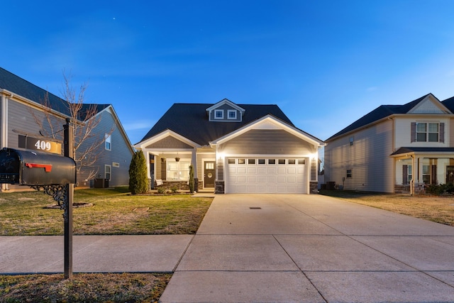 view of front of property featuring stone siding, concrete driveway, a garage, and a front yard