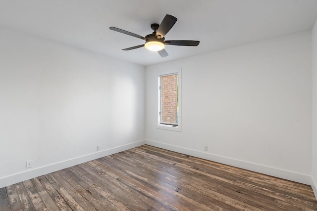 spare room with a ceiling fan, hardwood / wood-style flooring, and baseboards