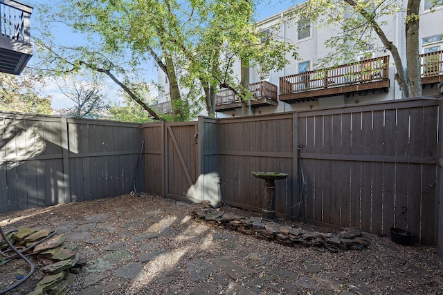 view of yard featuring a fenced backyard and a gate