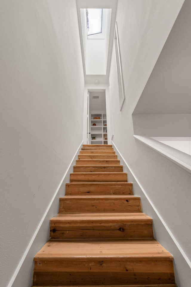 staircase with a skylight