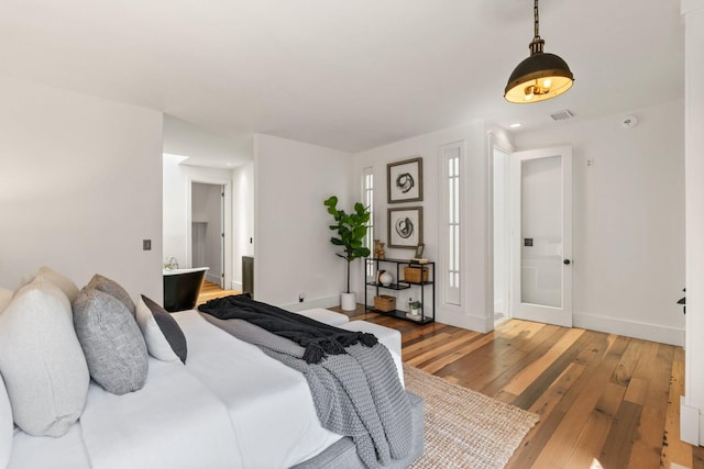 bedroom with light wood-type flooring, baseboards, visible vents, and recessed lighting