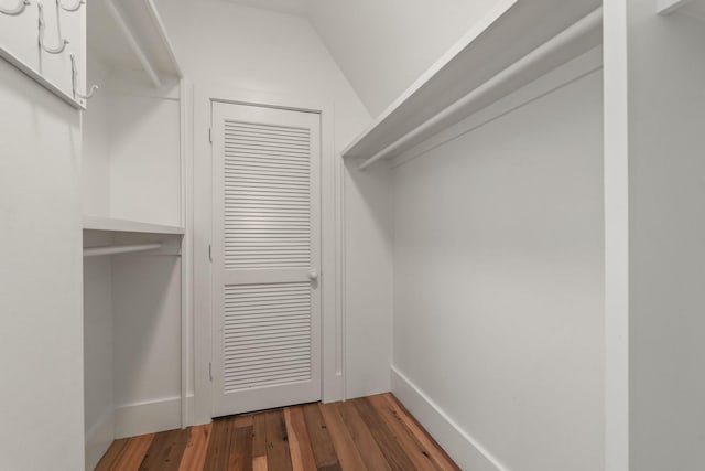 walk in closet featuring vaulted ceiling and wood finished floors