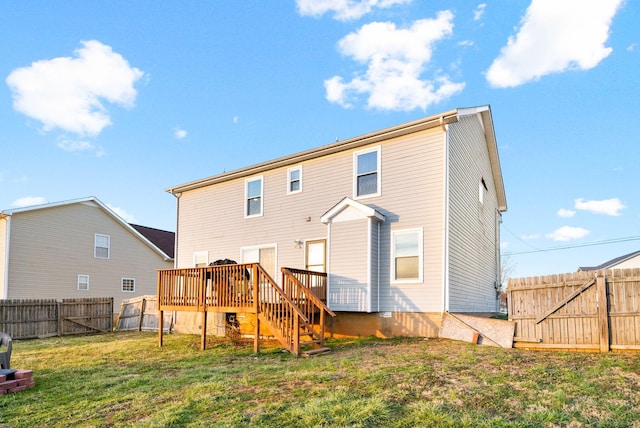 rear view of house with a fenced backyard, a deck, and a lawn