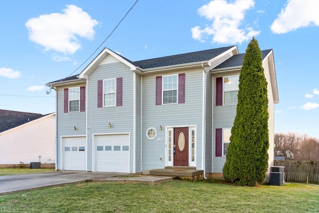 view of front facade with driveway, a garage, fence, cooling unit, and a front yard