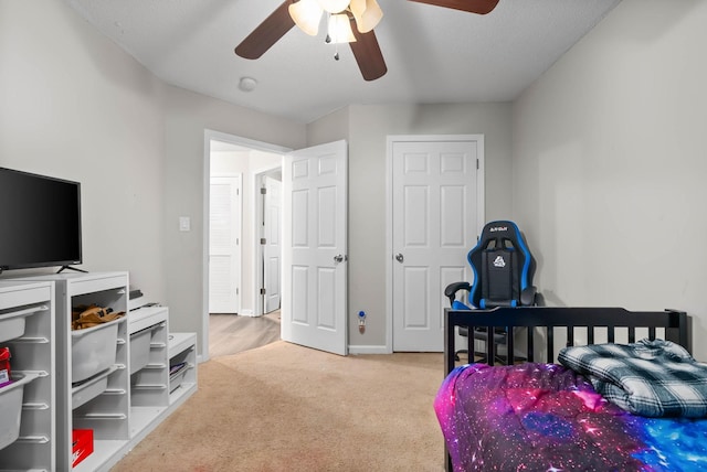 bedroom featuring baseboards, a ceiling fan, and carpet flooring