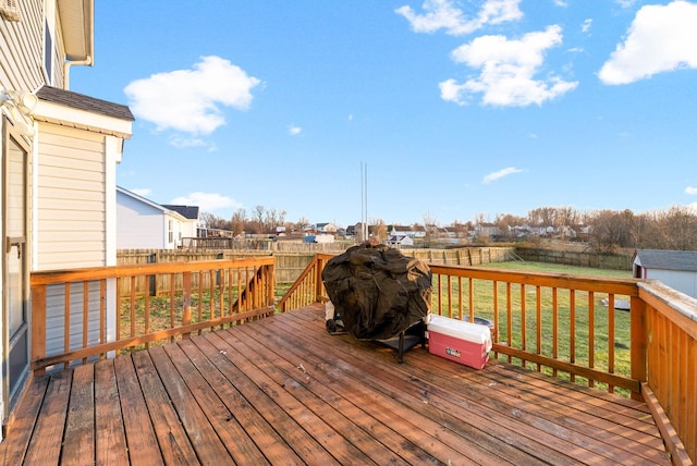 deck featuring a fenced backyard and a lawn