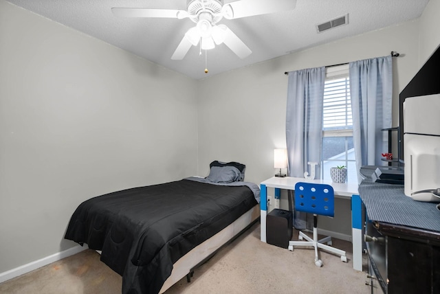 bedroom with baseboards, visible vents, ceiling fan, a textured ceiling, and carpet floors