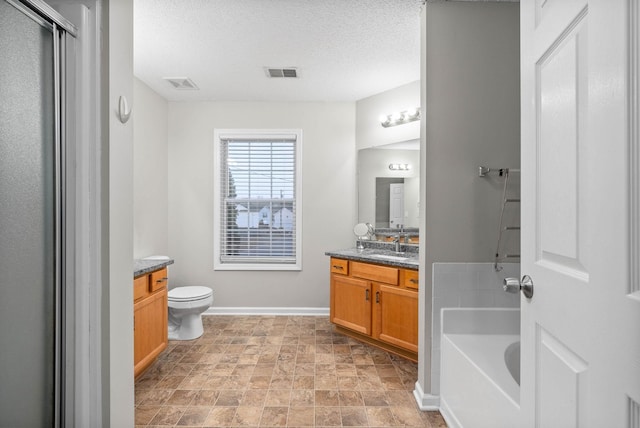 bathroom with a textured ceiling, a shower with shower door, vanity, and visible vents