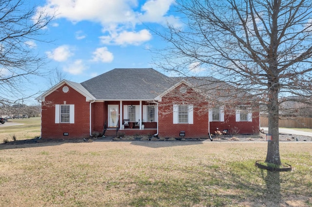 view of front of house with covered porch, crawl space, brick siding, and a front lawn